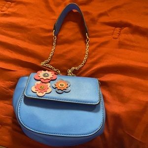 This is a kids bag. It’s blue with pink and blue flowers.